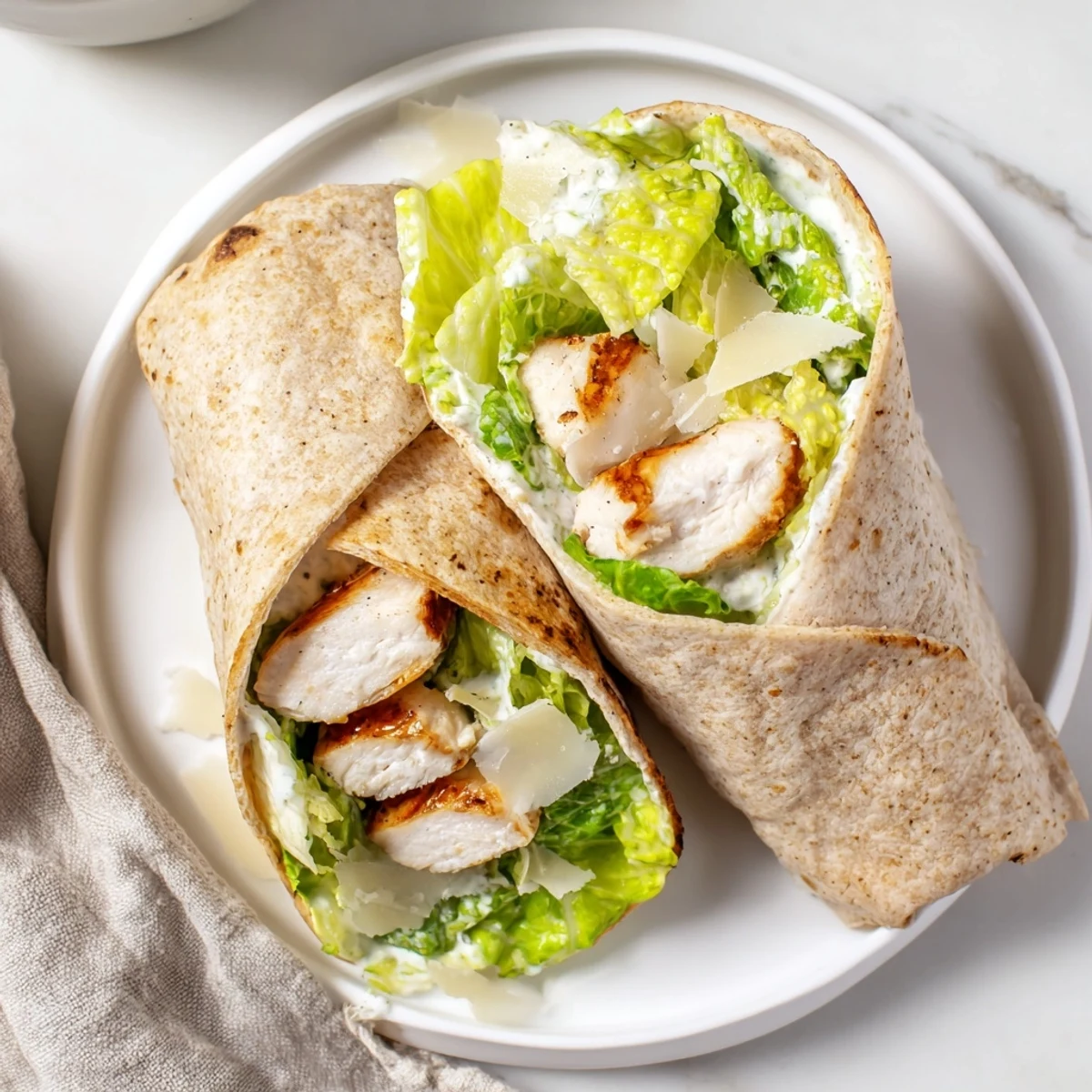 Grilled Chicken Caesar Wrap, beautifully assembled with vibrant greens, ready for a delicious bite.