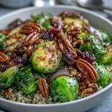 A nutritious Roasted Brussels Sprouts Bowl garnished with toasted pecans and dried cranberries, offering a wholesome vegan dinner idea for busy weeknights.