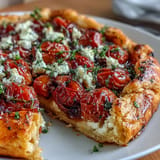 Golden-brown Roasted Cherry Tomato and Feta Galette, perfect as an appetizer.
