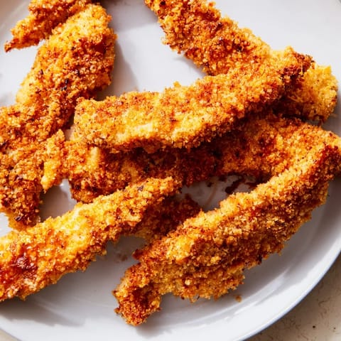 Freshly fried chicken tenders, perfectly breaded and ready for your delicious meal.