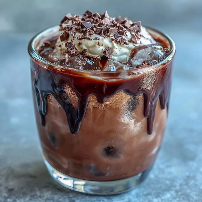 Velvety chocolate cream floats atop chilled cold brew coffee, creating a decadent layered beverage with deep mocha notes.