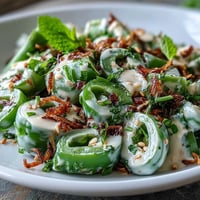 Vibrant snap pea and radish spring salad with creamy tahini dressing.